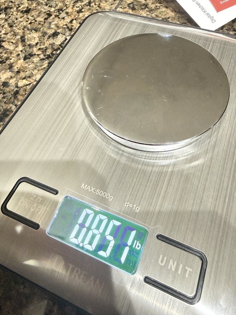Kitchen scale reading 0.851 pounds with the disc on it